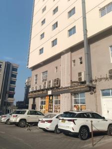 a group of cars parked in front of a building at Bait Alhoor in Muscat