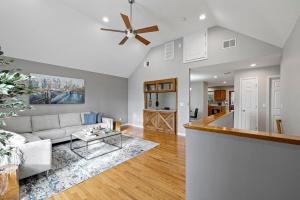 a living room with a couch and a ceiling fan at Modern Country Retreat near Legoland w Backyard in Chester