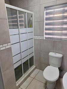 a bathroom with a toilet and a window at 310 Bonnyvale in Kempton Park