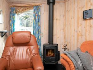 a leather chair and a stove in a room at 4 person holiday home in Vinderup-By Traum in Vinderup +29 photos