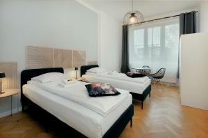 a hotel room with two beds and a dining room at Roomy apartment Łobzowska Street in Kraków