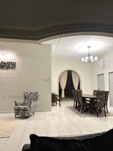 a living room with a table and chairs at Rooma63 Pekan Pahang - Musliem Only in Pekan
