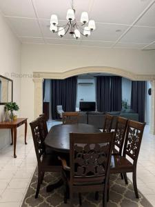 a dining room with a table and chairs at Rooma63 Pekan Pahang - Musliem Only in Pekan
