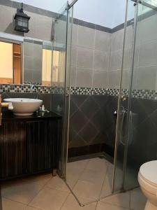 a bathroom with a shower and a sink at Hotel Purnama Lenggang in Gantung