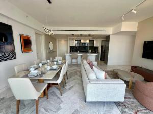 a living room with a couch and a table and chairs at Luxury apt in Panama City 2 Rooms 3 Baths office in Panama City