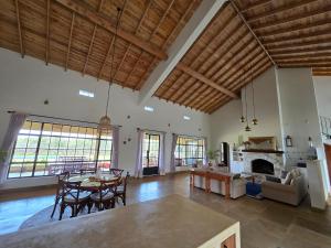 a large living room with a table and a fireplace at Kipepeo Villa in Naivasha