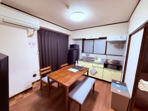 a small kitchen with a wooden table in a room at Stay Plus Sophia in Utsunomiya +36 photos