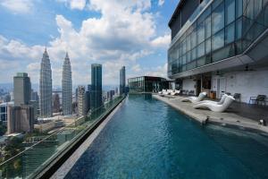 a swimming pool on top of a building with a city at Imperial Luxury Suites KLCC by Moonway in Kuala Lumpur