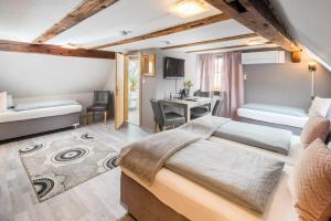 a bedroom with a bed and a desk at Hotel Nürnberger Hof in Altdorf in Altdorf bei Nuernberg +54 photos