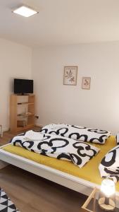 a bedroom with a bed with a black and white blanket at ME Apartments Würges 1 2 8 in Bad Camberg