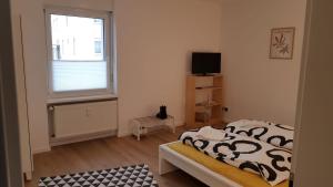 a small bedroom with a bed and a window at ME Apartments Würges 1 2 8 in Bad Camberg