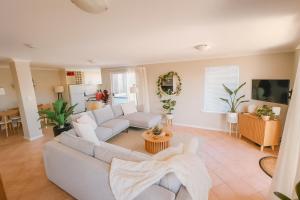 a living room with a couch and a table at Waterfront bliss, spacious corner block in Mandurah