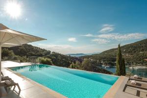 a swimming pool with a view of a mountain at Villa Roya in Sivota