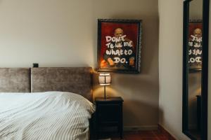 a bedroom with a bed and a picture on the wall at Au pied du pré, Appartement 6P in Verviers