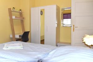 a bedroom with a bed and a door and a chair at GUWO Gästewohnung Friedrich-Engels-Str 5 in Sprucke