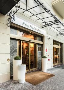 a store front of a building with large white pots at Nuovo Hotel Del Porto in Bologna