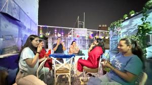 a group of women sitting around a table at a party at Ghumakkad Jodhpur in Jodhpur