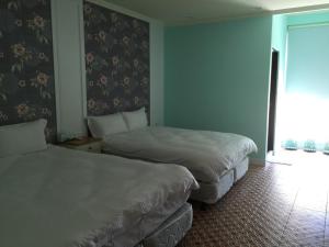 Een bed of bedden in een kamer bij Pretty Nanwan B&B