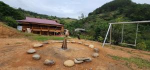 a building on a dirt field with a soccer goal at Trạm Thẩm Lé in Văn Chấn