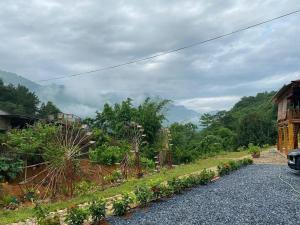 a view of a garden with mountains in the background at Trạm Thẩm Lé in Văn Chấn +2 photos