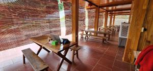 a patio with benches and a laptop on a table at Trạm Thẩm Lé in Văn Chấn