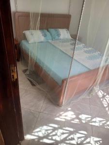 Postel nebo postele na pokoji v ubytování Scandinavia-Nordic House in Entebbe