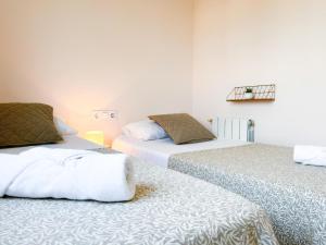 two beds sitting next to each other in a room at Apartment Sunset in Cunit +31 photos