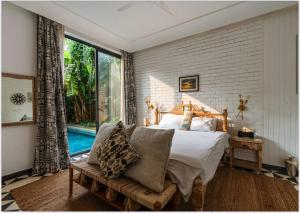 a bedroom with a bed and a large window at 3 Bedroom Private Pool Villa in North Goa by Amorey Stays in Vagator