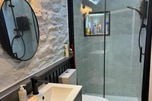 a bathroom with a shower and a sink and a mirror at Family-Pet Friendly-Sleeps 10-Hot Tub-Sauna in Barnagowlane