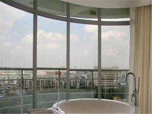 a bath tub in a room with a large window at Hiyet Oriental Hotel in Zhongshan