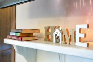 a shelf with a house and books on it at Villetta Monica in Costa Paradiso