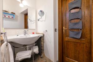 a bathroom with a sink and a mirror at Villetta Monica in Costa Paradiso +41 photos