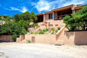 a house with stairs in front of it at Villetta Monica in Costa Paradiso