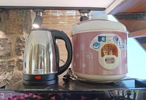 a tea kettle and a toaster sitting on a counter at Villa Pinokio W BBQ & Backyard in Bandung