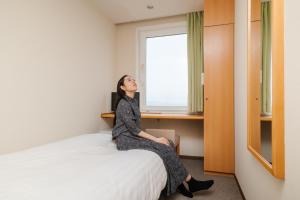 Postel nebo postele na pokoji v ubytování Kur and Hotel Suruga + 56 fotografií