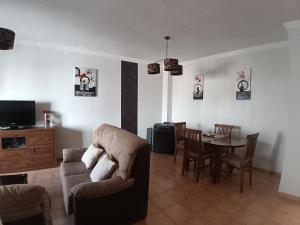 a living room with a couch and a table at Casa rural Sabina in Montejaque