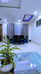 a room with a table and a potted plant at Cassava Stay in New Delhi
