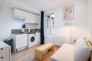 a kitchen and living room with a washer and dryer at Apartment Perron - Cozy 2 people - Oullins in Oullins