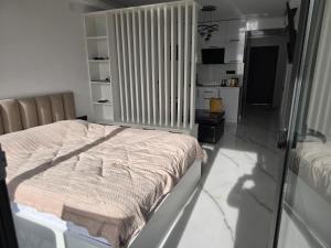 a bedroom with a bed and a tv in it at Blue sky in Itʼkhvisi