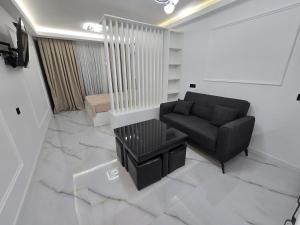 a living room with a couch and a table at Blue sky in Itʼkhvisi