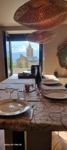 a counter with two sinks and a view of a castle at Le Panoramic in Err
