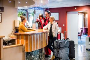 a group of people standing at a counter in an office at Villages Clubs du Soleil - VARS in Vars