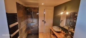 a bathroom with two sinks and a shower at Le Panoramic in Err