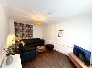 a living room with a couch and a tv at Landhaus Heidhof in Wettringen +14 photos