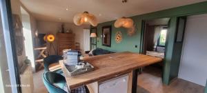 a kitchen with a wooden counter and some chairs at Le Panoramic in Err