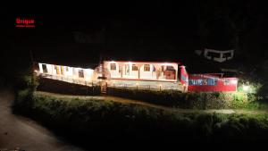 a house lit up at night with lights at Global home stay in Sari