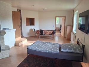 a living room with a bed and a table at Gute Laune 3 in Zapel