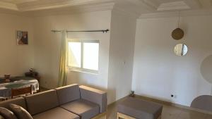 a living room with a couch and a window at Appartement Seyive in Cotonou