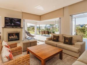 a living room with a couch and a table at GolfersHeaven Kingswood Golf Estate in George