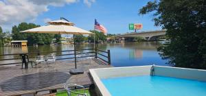 a patio with an umbrella and a swimming pool at RVH Kuala Terengganu in Kuala Terengganu